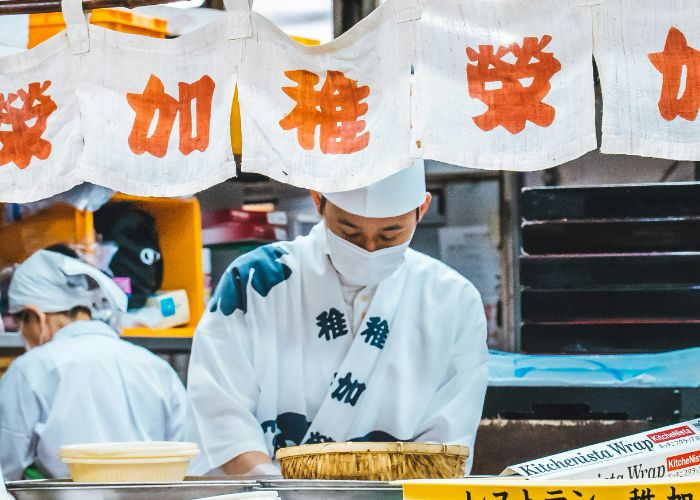 A chef working hard in a kitchen in Fukuoka.